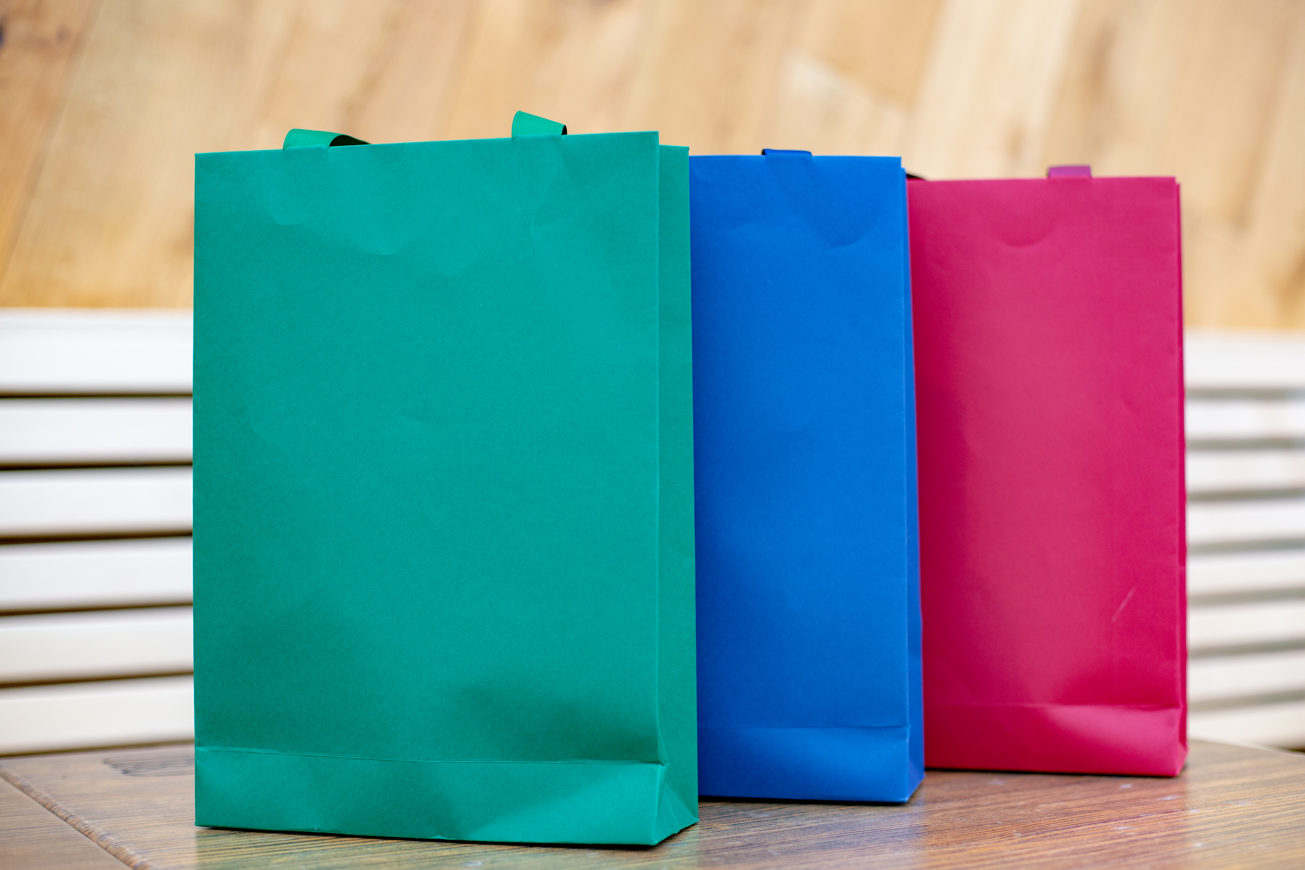 Stack of flat-folded kraft paper bags.