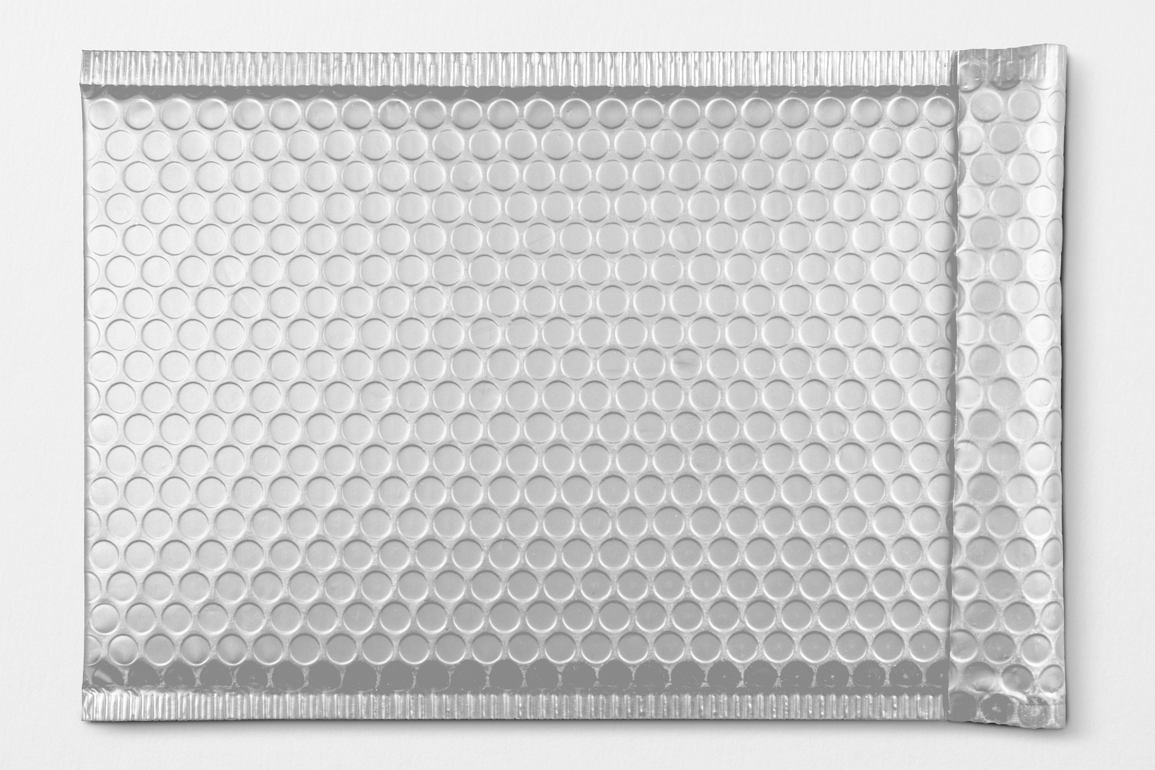 Aluminium honeycomb foil sheet folded to show both sides.