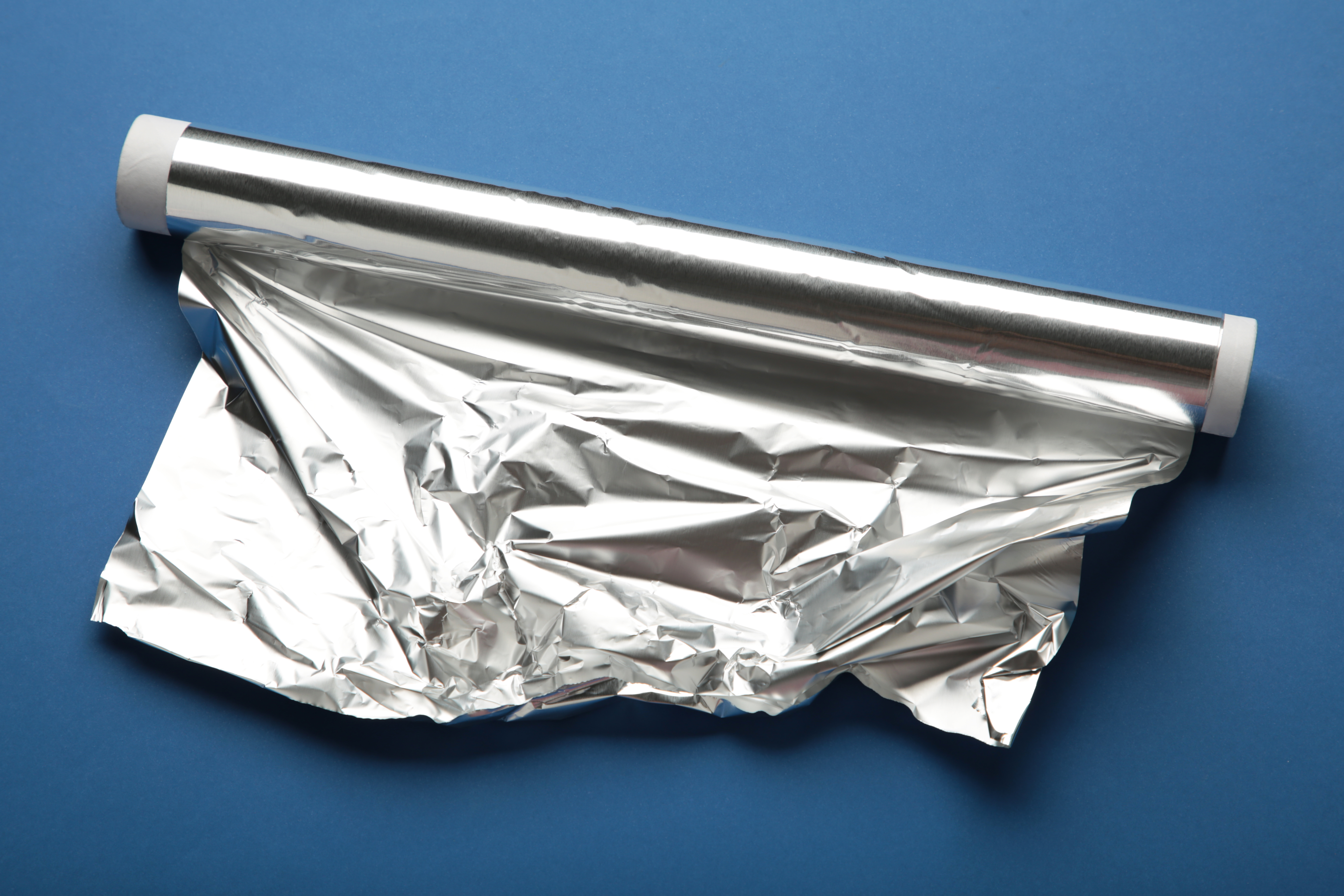 Aluminium foil production roll on factory floor.