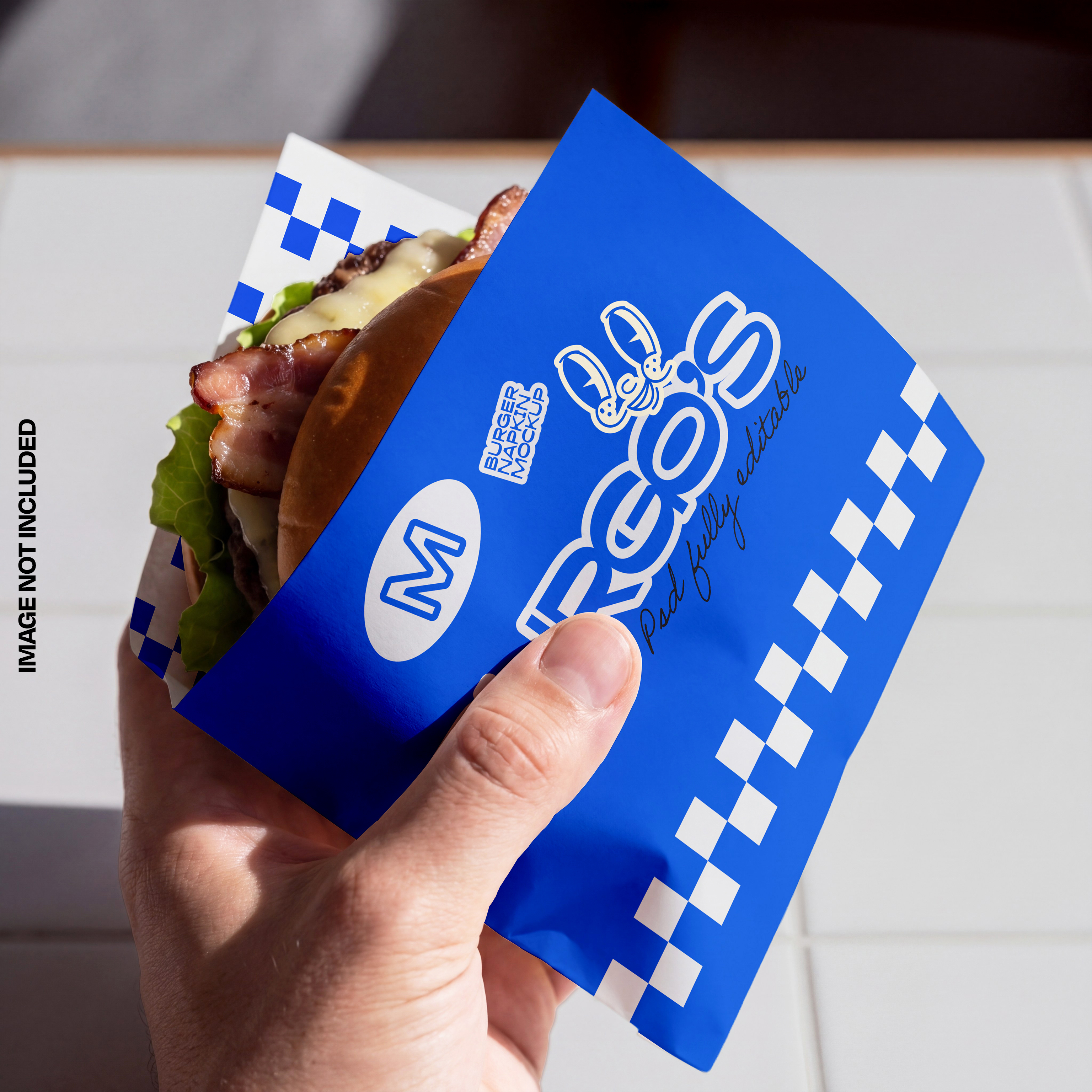 Printed food paper wrap with leaf motif holding a sandwich.